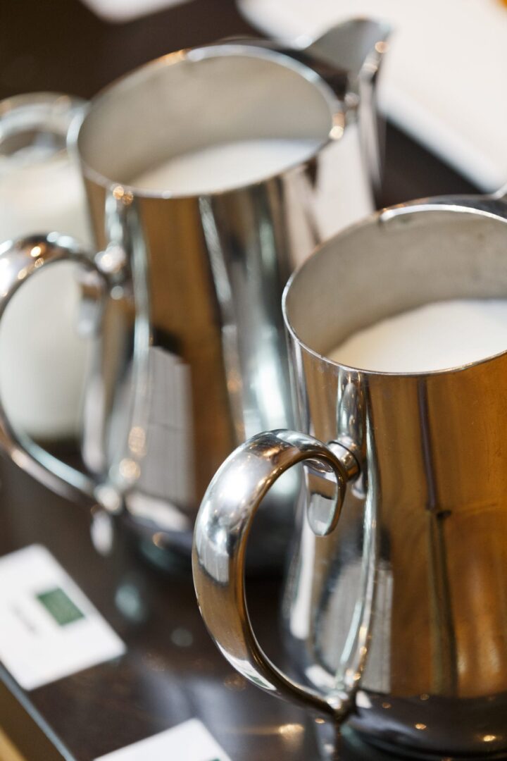 A close up of two silver cups on top of a table.