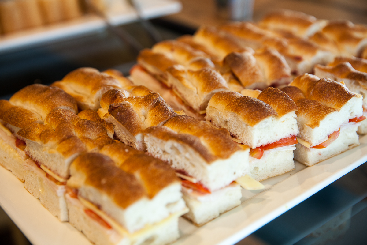 A tray of sandwiches on top of a table.