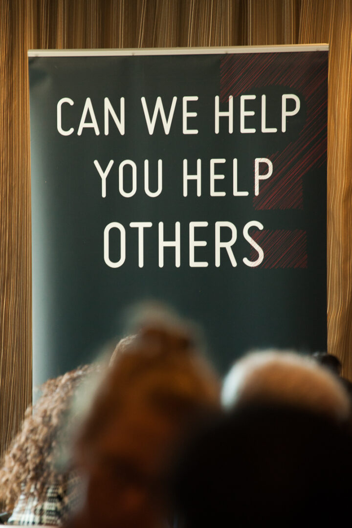 A sign that says, " can we help you help others ".