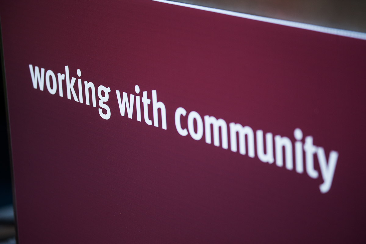 A close up of the words working with community